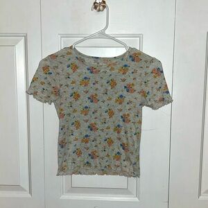 An American Eagle shirt and is an extra small. Is light gray with flower pattern